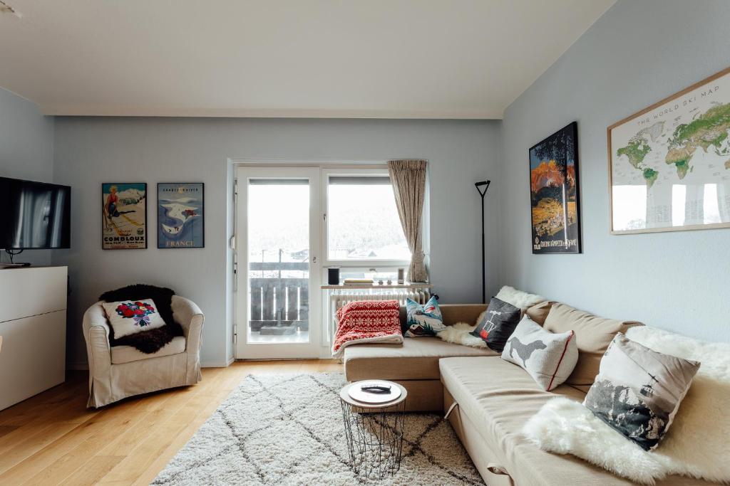 a living room with a couch and two chairs at Appartement SISI by MoniCare in Seefeld in Tirol