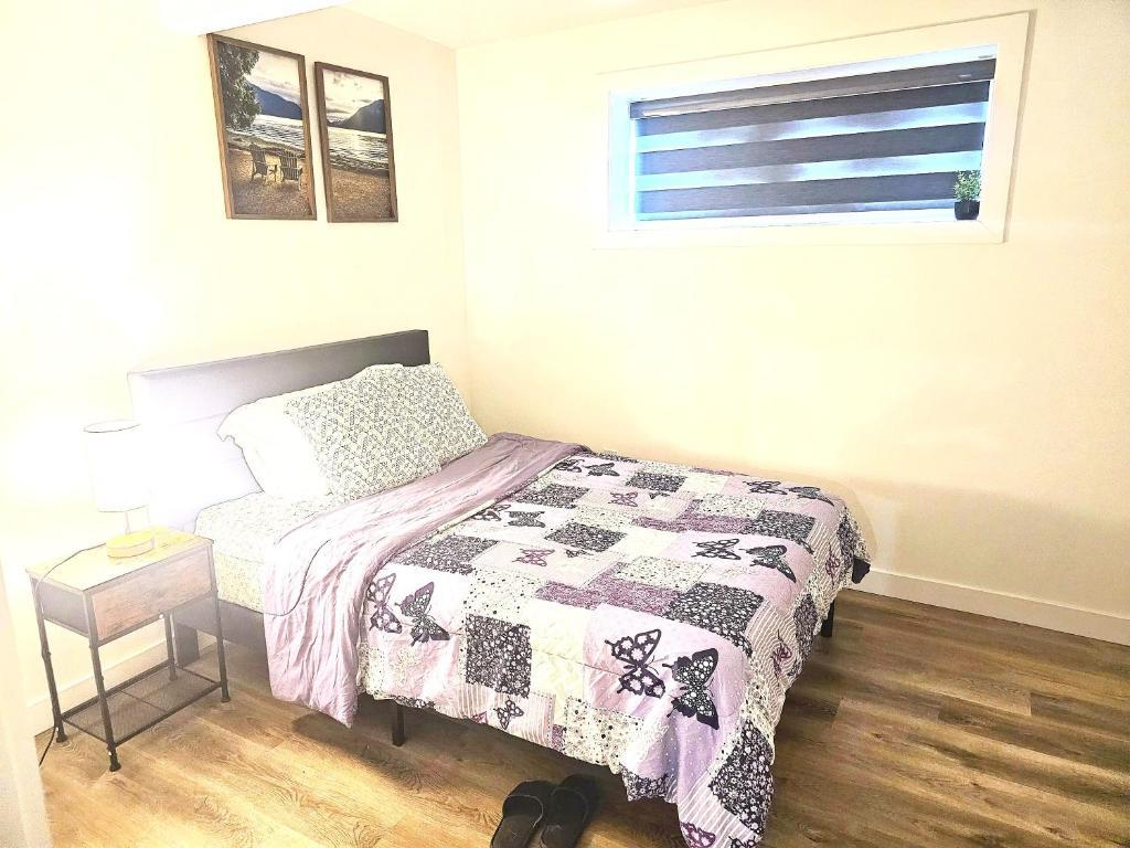 a small bedroom with a bed and a window at Snug 2 bedroom sleeps 5-Netflix in Edmonton