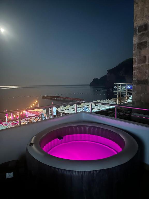 a hot tub with pink lighting on a balcony at Lili's Sea View in Budva