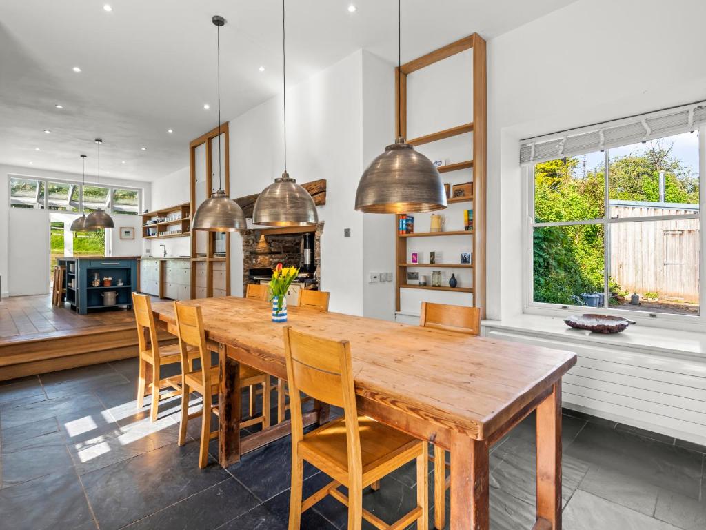 a kitchen and dining room with a wooden table and chairs at Chantry in Kingsbridge