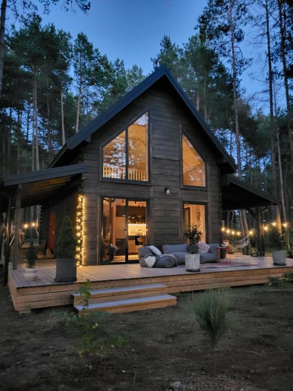 a cabin in the woods with a lot of windows at Nobelowka Forest SPA in Huta Podgórna