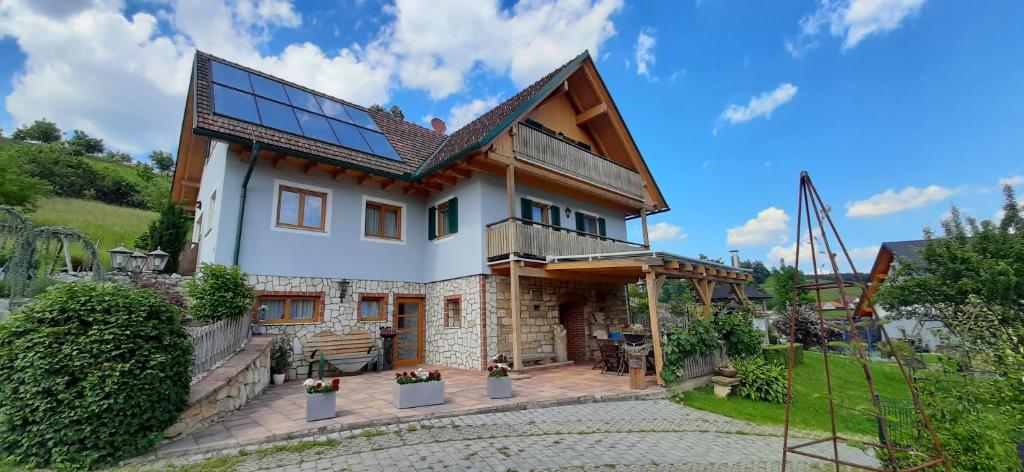 a house with solar panels on the roof at Ferienhaus Zotter in Feldbach