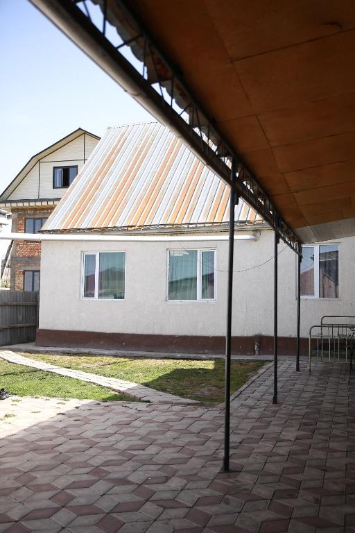 a large white building with an orange roof at Central Guest House Karakol in Karakol