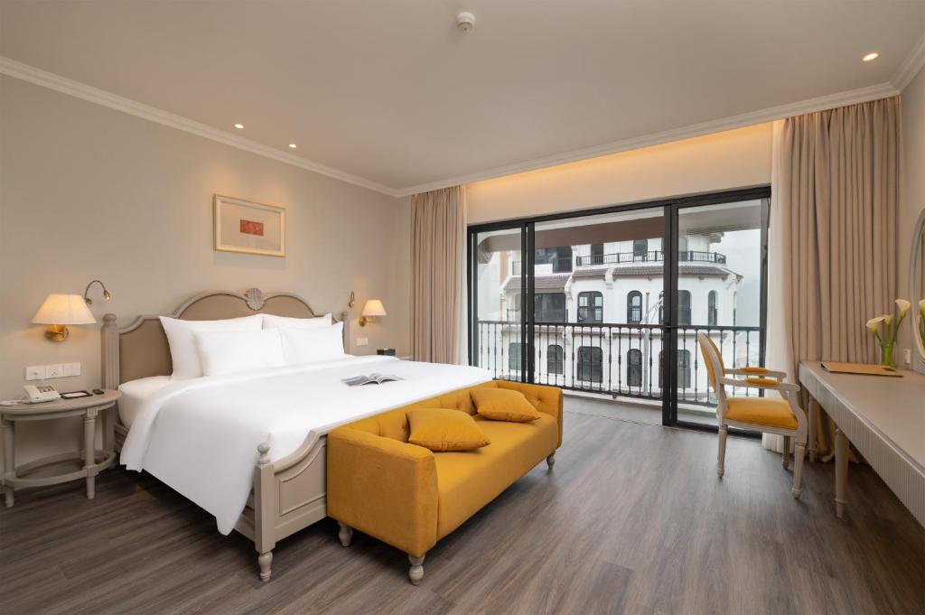 a hotel room with a large bed and a desk at Hotel Montmartre de Sapa - Newly Opened April 2026 in Sapa