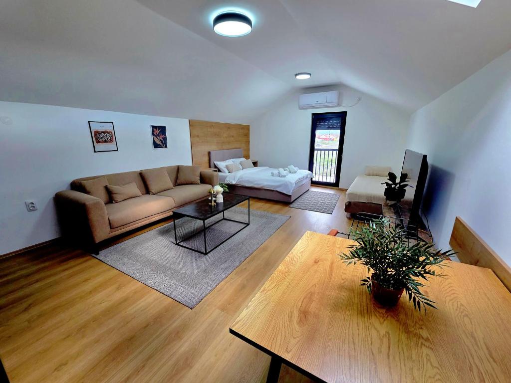 a living room with a couch and a table at Promo Studio Apartment in Pirot