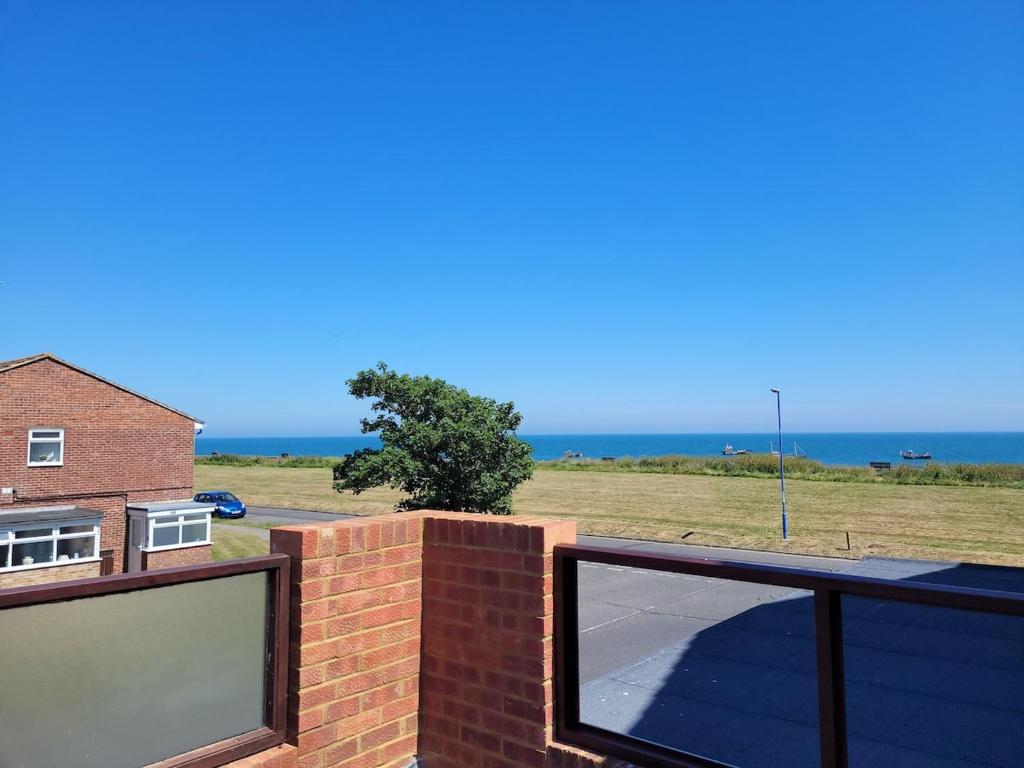 a view of the ocean from the balcony of a house at Pebble Beach, ground floor 1 bedroom flat in Chichester