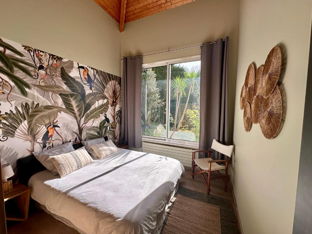 a bedroom with a bed and a large window at Villa Ongizatea au calme avec piscine et vue montagne in Urrugne