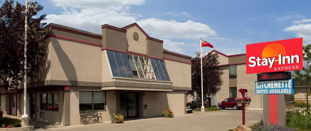 a building with a sign in front of it at Stay Inn Express Toronto in Toronto