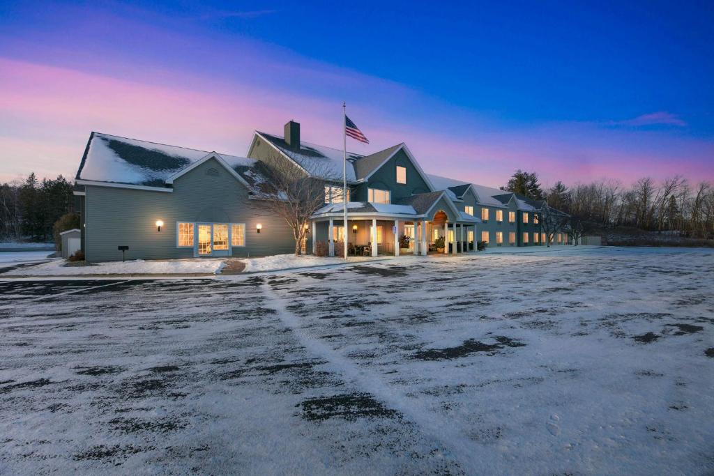 a house with an american flag on top of it at Country Inn Walker in Walker