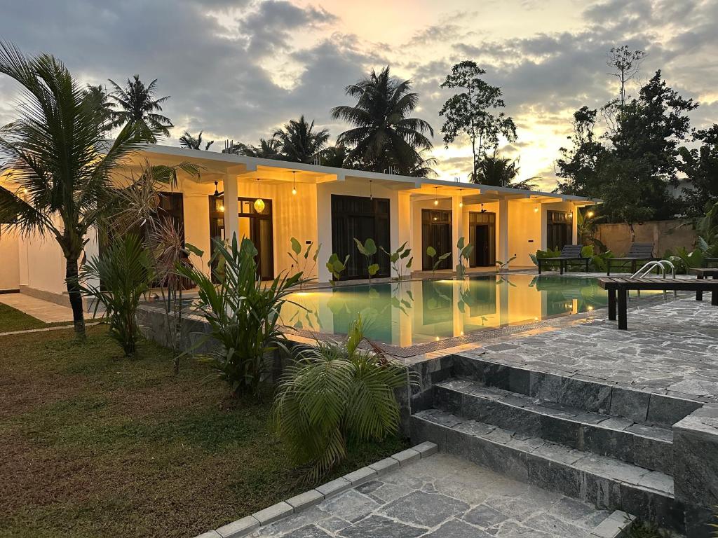 a house with a swimming pool in front of it at Era 25 in Ahangama