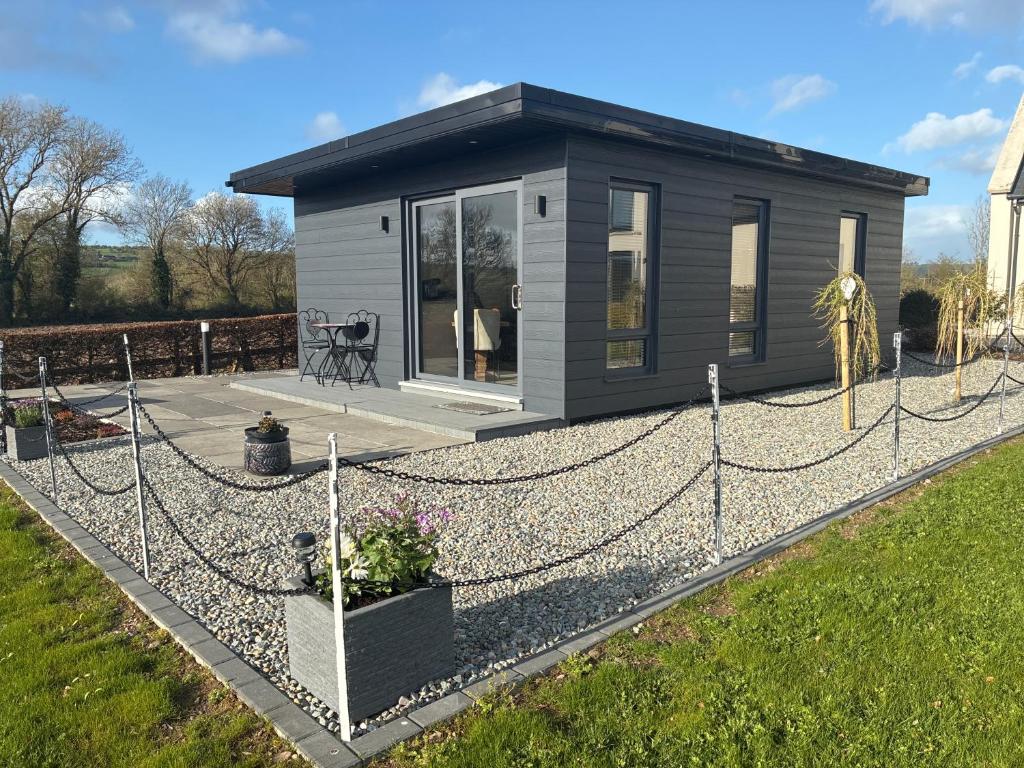 a tiny house with a chain fence around it at Heron's Rest Studio in Macroom