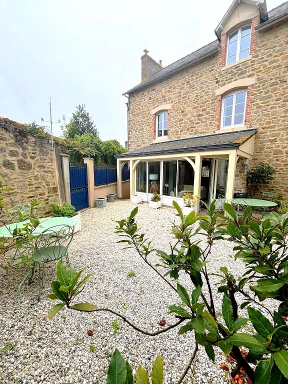 a large brick house with a gravel yard at Maison Suzanne, Downtown, 6 Guests in Cancale