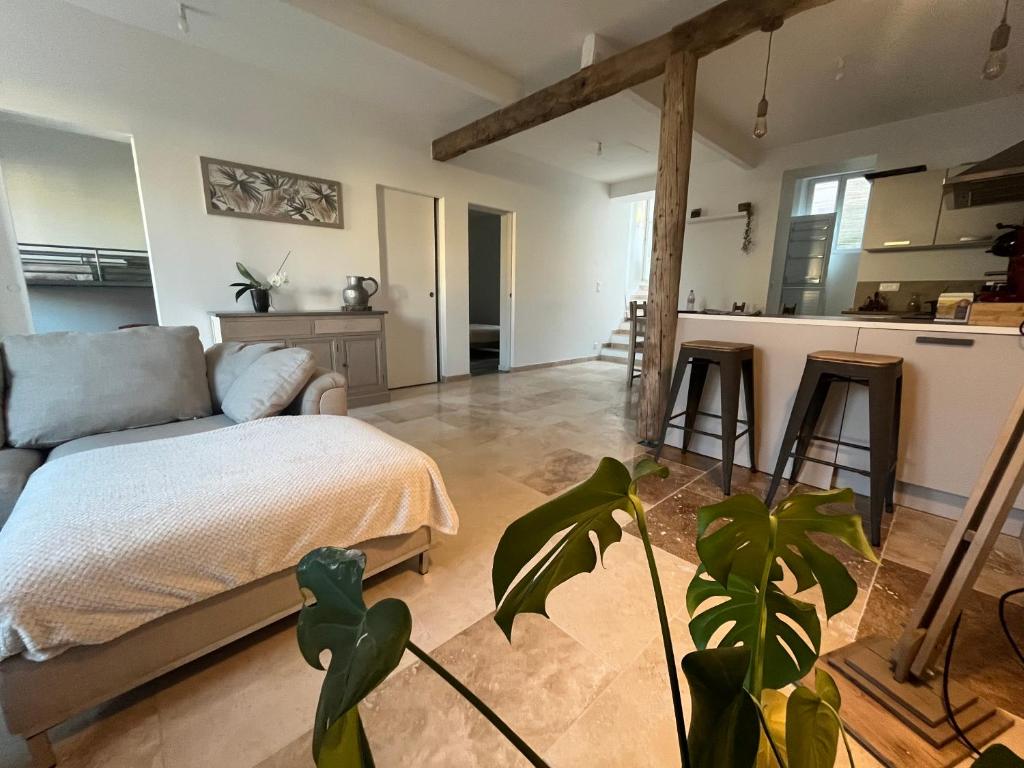 a living room with a bed and a kitchen at la petite colline in Cavaillon