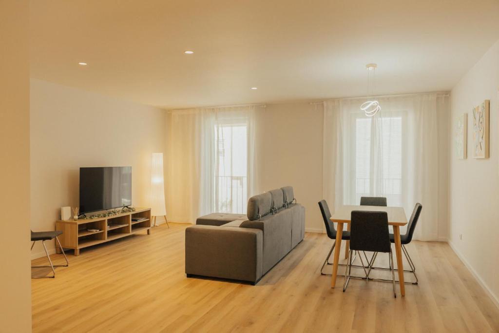 a living room with a couch and a table at Termas do Gerês Studio in Geres