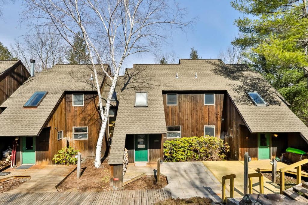 a large wooden house with a wooden deck at Windham Mountain Condo with Deck & Stunning Views in Windham