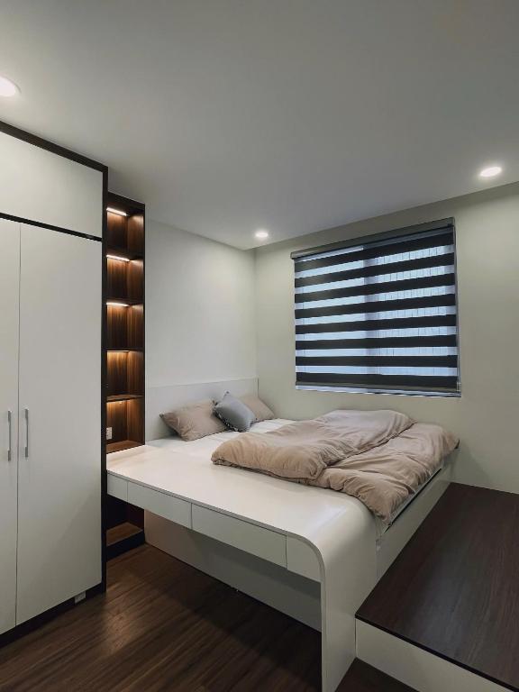 a large bed in a room with a window at KP Home in Xuân Trach