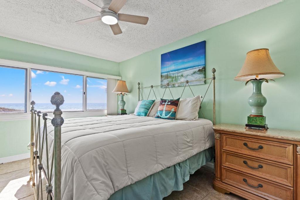 a bedroom with a bed and a ceiling fan at A-110, Pinnacle Port in Panama City Beach