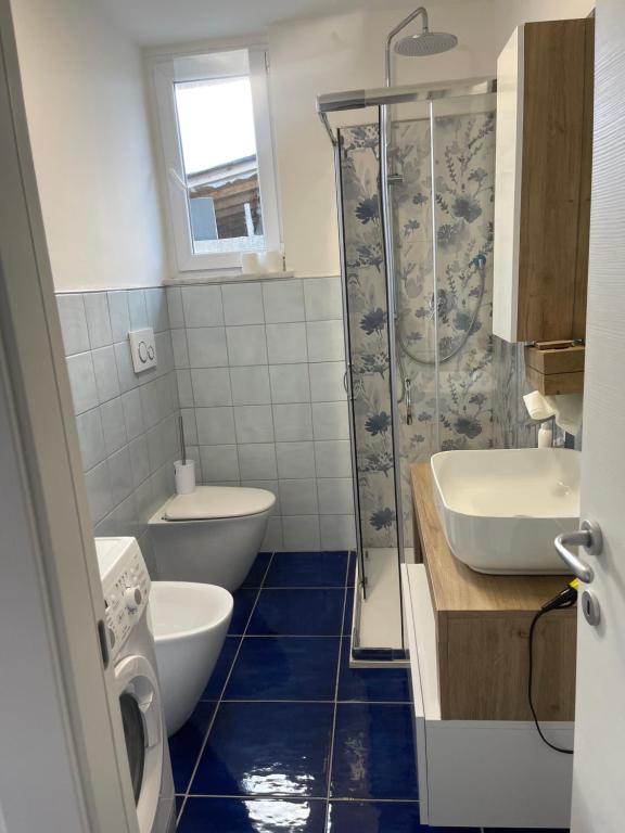a bathroom with a toilet and a sink and a shower at MAGA House in Pontecagnano