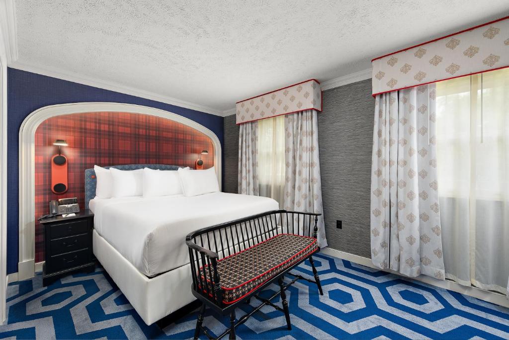 a hotel room with a bed and a chair at Nemacolin in Farmington