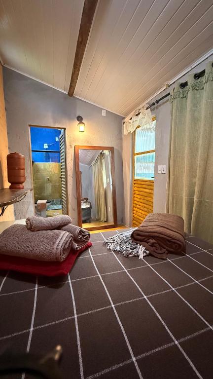 a bedroom with two beds on the floor and a window at Chalé Orion in Lençóis