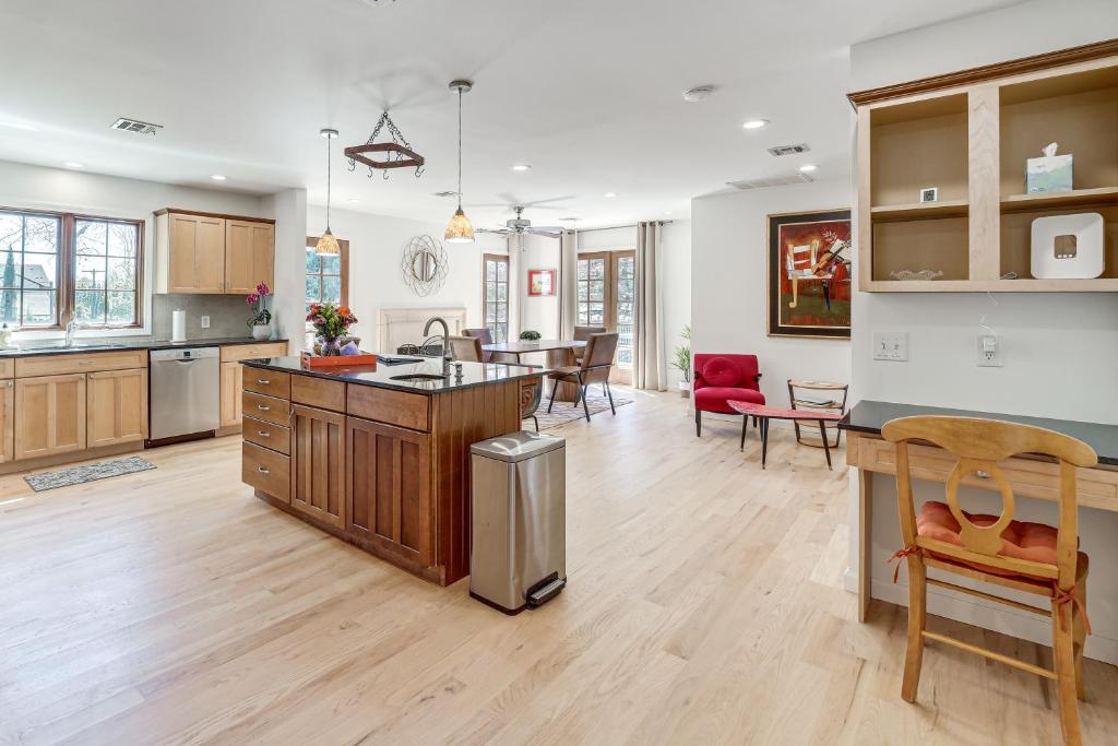 a kitchen and living room with a table and chairs at Midtown Tulsa Gem w/ MCM Decor: Private Deck, Yard in Tulsa