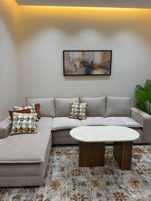 a living room with a couch and a table at شقق سدايم in Jeddah