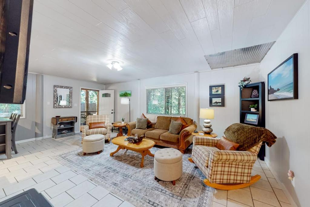 a living room with couches and a table at Coastal Cabin in Gualala