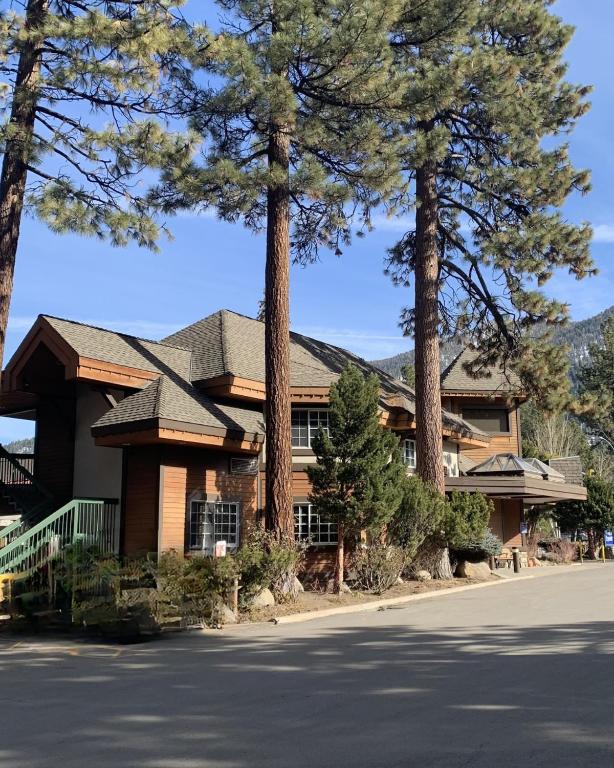 a house with trees in front of a street at HiMark Hotel in South Lake Tahoe