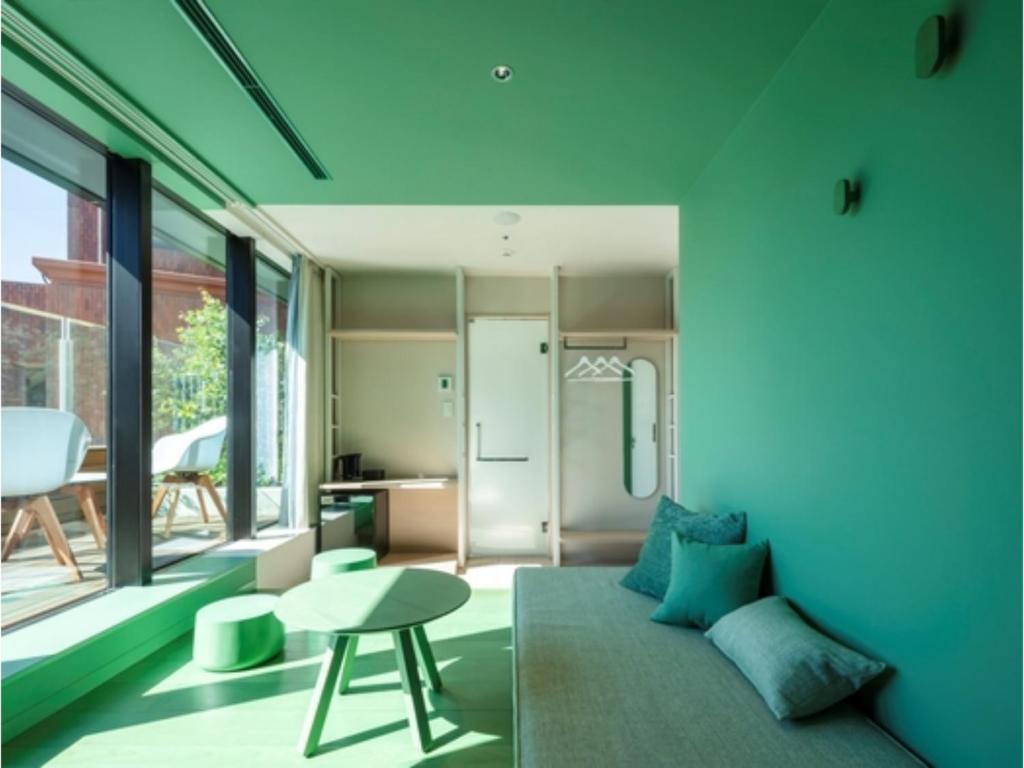 a living room with a couch and a table at toggle hotel suidobashi - Vacation STAY 06279v in Tokyo