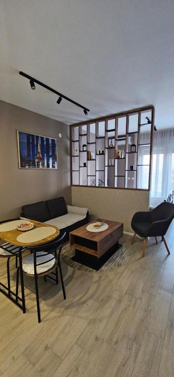 a living room with a couch and a table at Apartman Filip in Paraćin