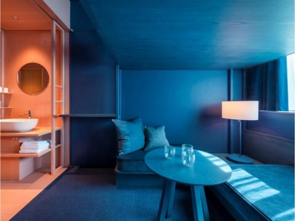 a blue room with a table and a sink at toggle hotel suidobashi - Vacation STAY 13410v in Tokyo
