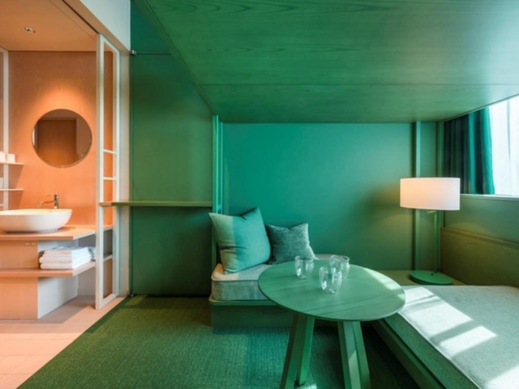 a room with a bed with a table and a sink at toggle hotel suidobashi - Vacation STAY 13415v in Tokyo