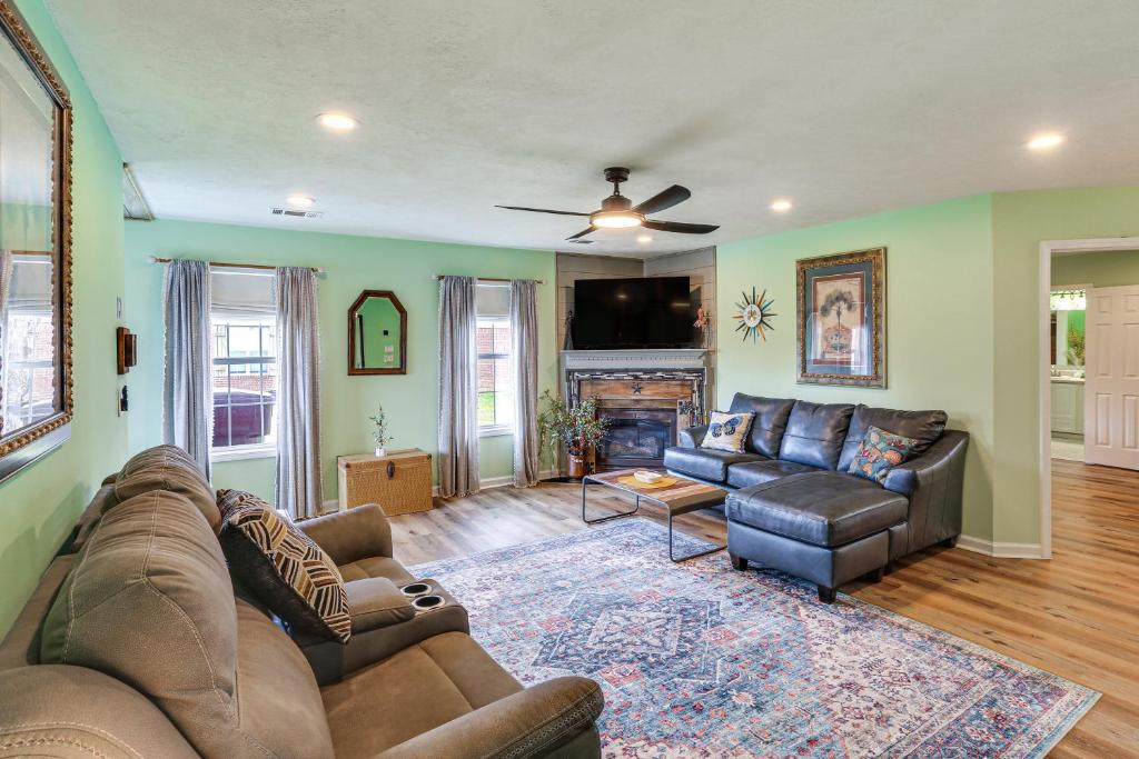a living room with two couches and a fireplace at Explore Tupelo & Natchez Trace! Southern Getaway in Tupelo