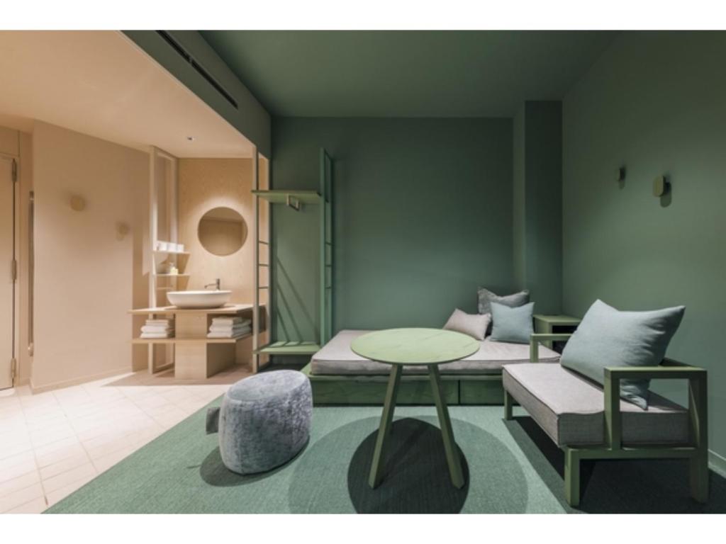 a room with a bed and a table and a chair at toggle hotel suidobashi - Vacation STAY 13465v in Tokyo