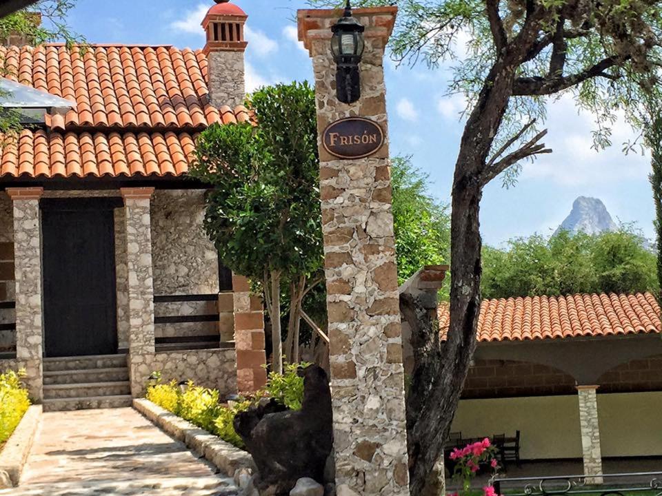 a building with a sign in front of it at Cabañas Rancho San Jorge in Bernal