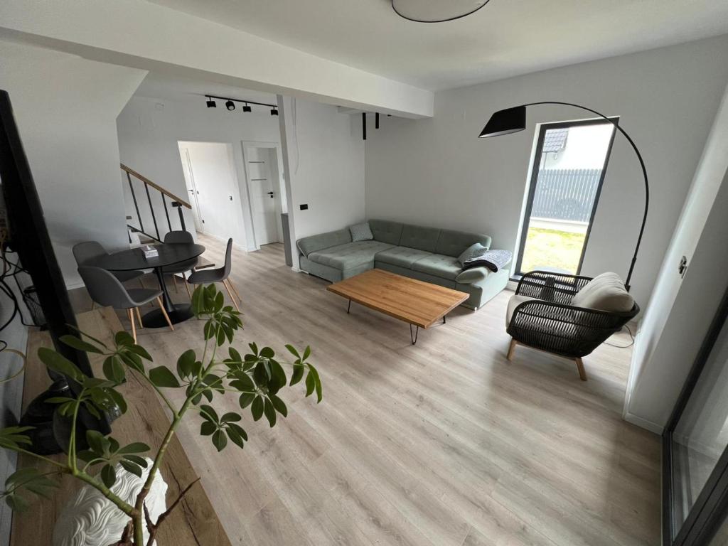 a living room with a couch and a table at ANON Mures in Livezeni