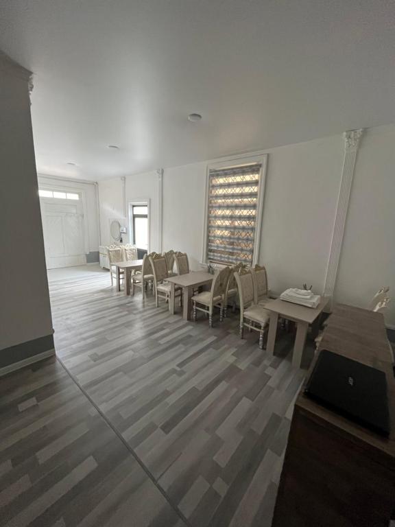 a room with chairs and tables and a window at Ichan Kala Silk Road Guest House in Khiva