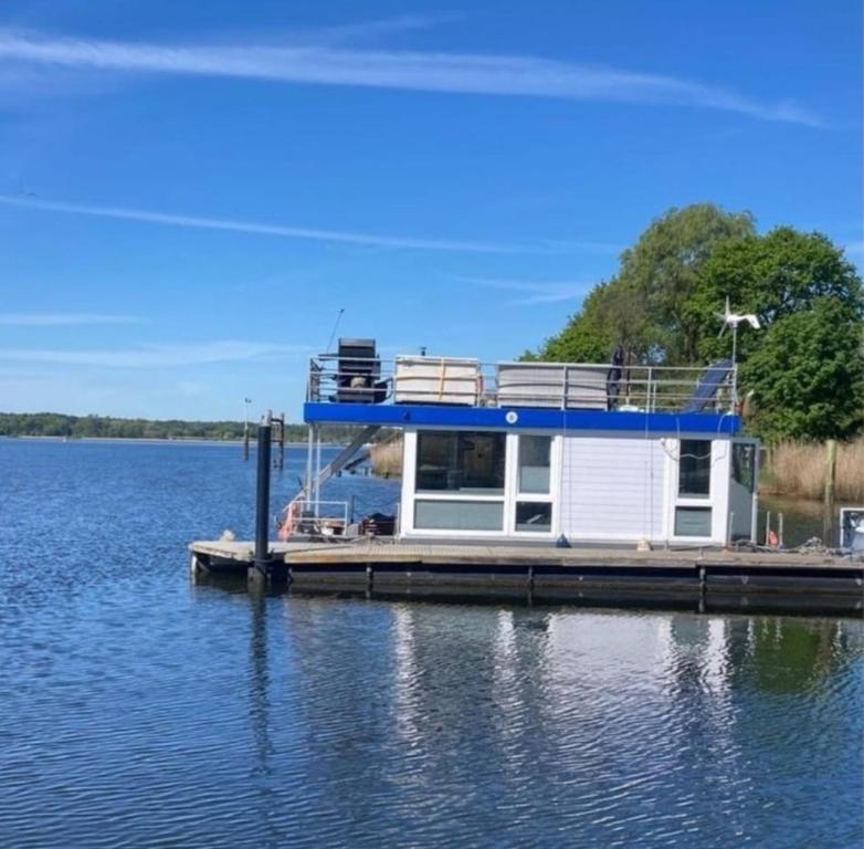 a boat docked at a dock on a lake at HausboootHL in Lübeck