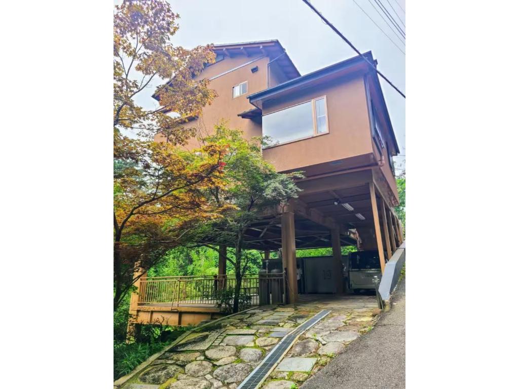 a house with a stone walkway in front of it at MAPLE HOUSE - Vacation STAY 13294v in Tsuru 