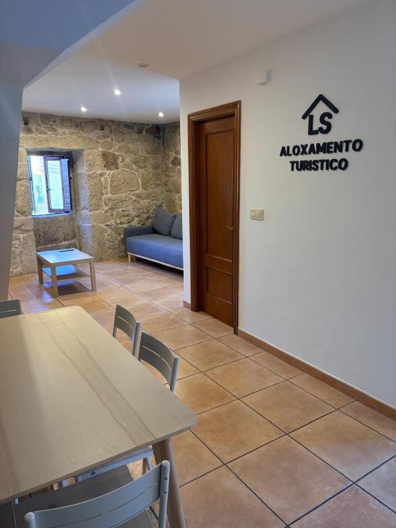 a waiting room with a table and a couch at LS Alojamiento Turístico in Arcade