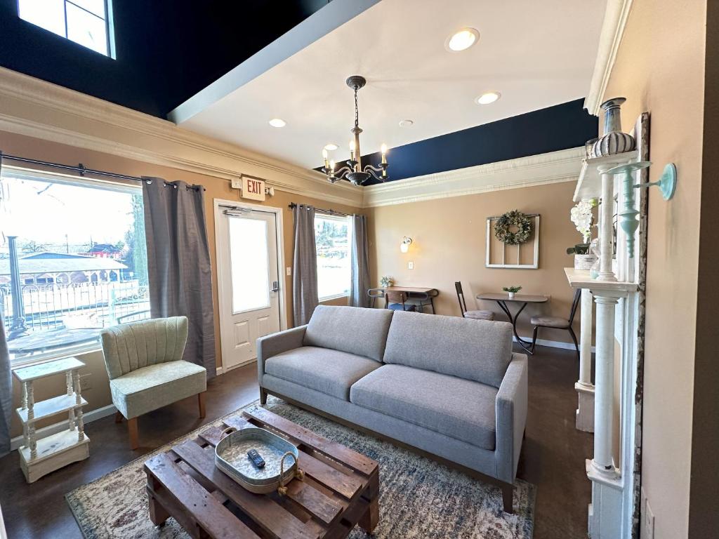 a living room with a couch and a table at Haven at Hazel Downtown Loft in Demorest
