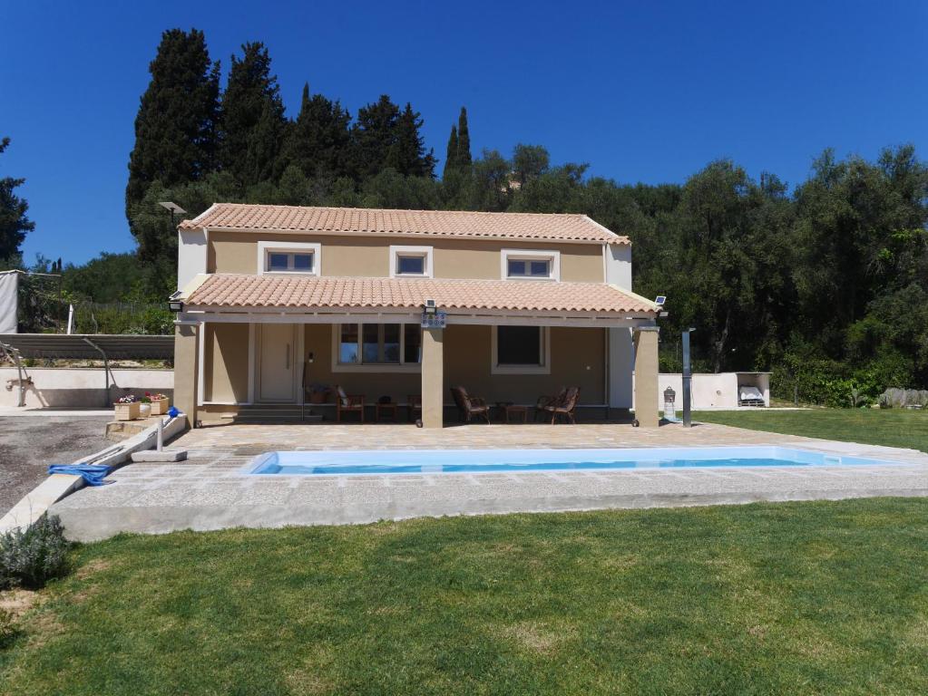 a house with a swimming pool in a yard at Private Villa Maothis in Corfu