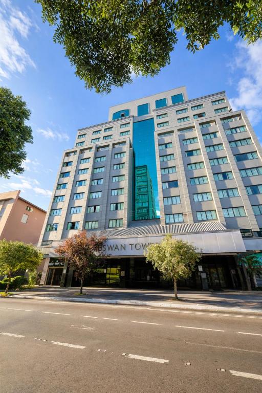 a large building with a sign on the front of it at Swan Caxias do Sul in Caxias do Sul