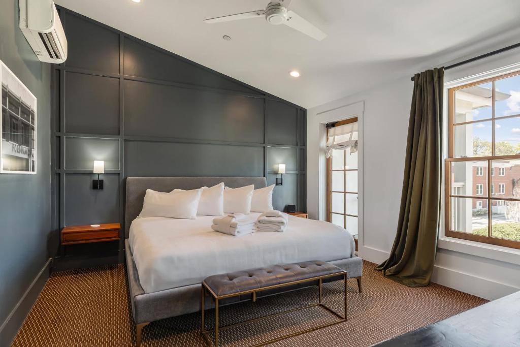 a bedroom with a large bed with a black headboard at Superior King Room at The Emerald in Beaufort
