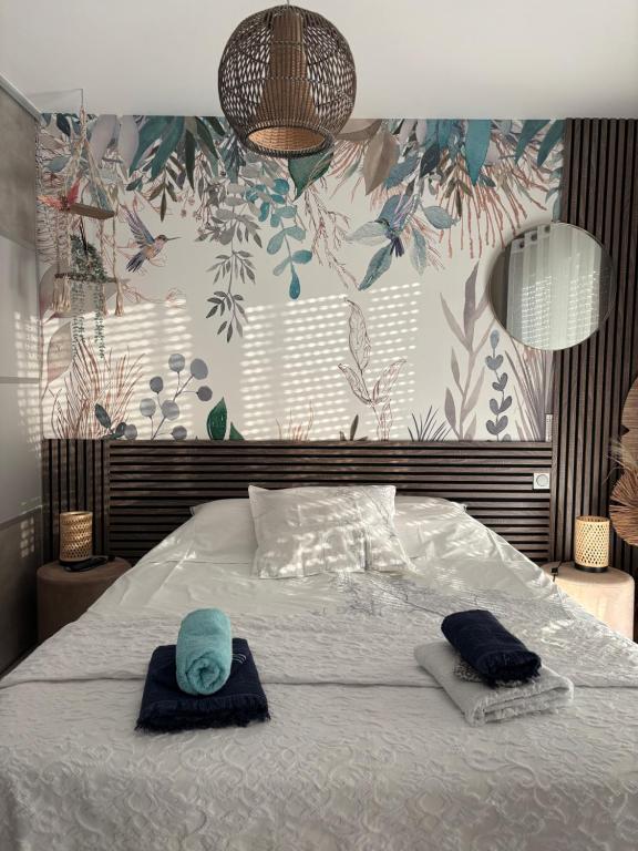 a bedroom with a bed with two hats on it at Chambre Circuit 24h in Spay