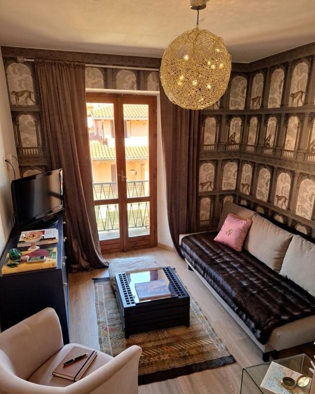 a living room with a couch and a table at Maison Lake Maggiore Art Stay,central Baveno, 60 mt from Lake and Hotel Dino Congress Center in Baveno