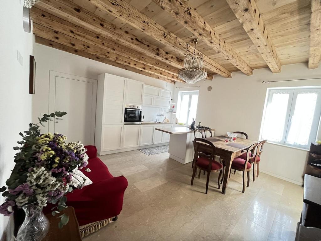 a living room with a red couch and a table at Papiria Residence in Piovene Rocchette