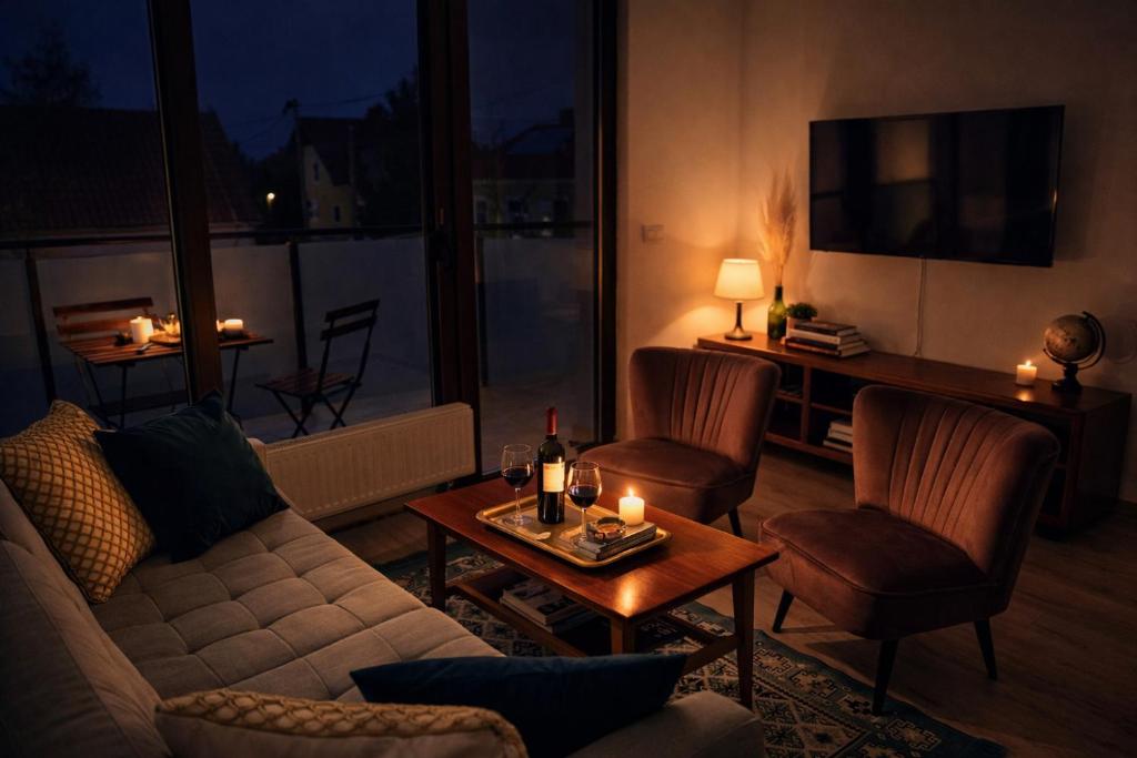 a living room with a couch and a table with candles at Erkel 19 Apartmanház in Keszthely