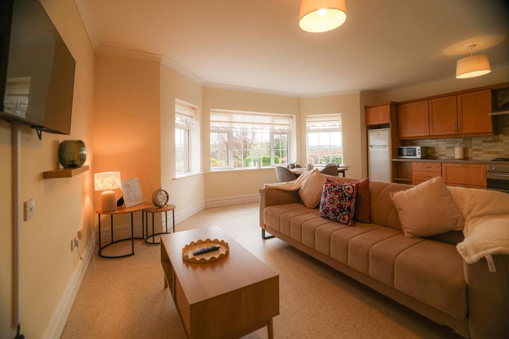 a living room with a couch and a table at Hillside House- Pine View in Ballinamuck