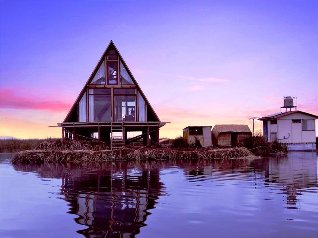 a house on an island in the water at Jutma Titicaca Lodge in Puno